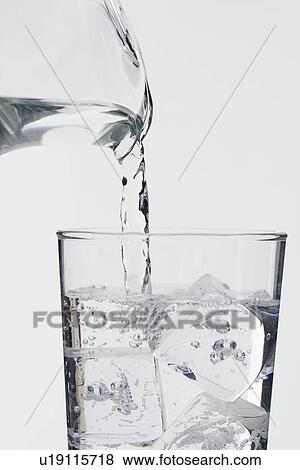 Stock Photo - Pouring a glass of ice water. Fotosearch