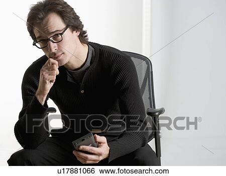 Stock Photograph - Professional man sitting thoughtfully. Fotosearch