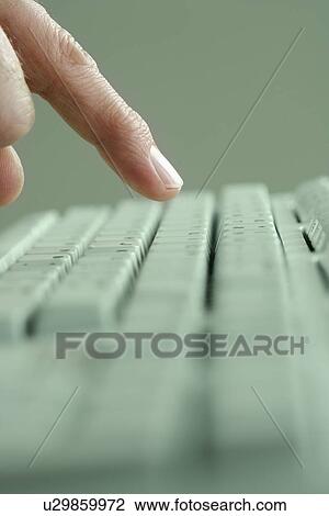 Stock Image - Profile of finger and computer keyboard. Fotosearch