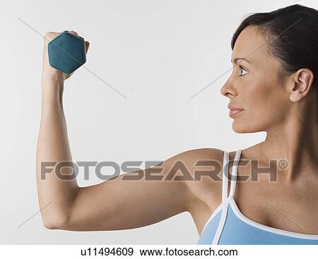 Stock Photo - Profile of woman with hand weight. Fotosearch