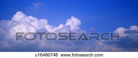Puffy clouds and blue sky View Large Photo Image Stock Photograph - Puffy clouds and blue sky. Fotosearch