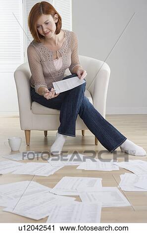 Redheaded woman sorting papers on floor View Large Photo Image Stock Image - Redheaded woman sorting papers on floor. Fotosearch