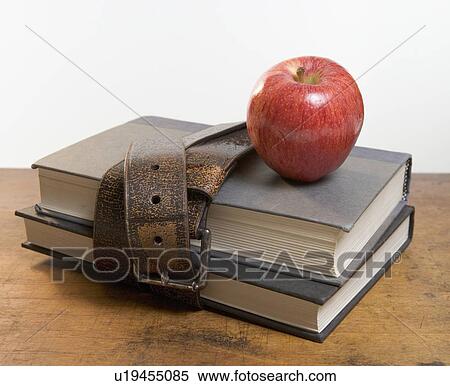 Stock Photography - Schoolbooks with red apple. Fotosearch