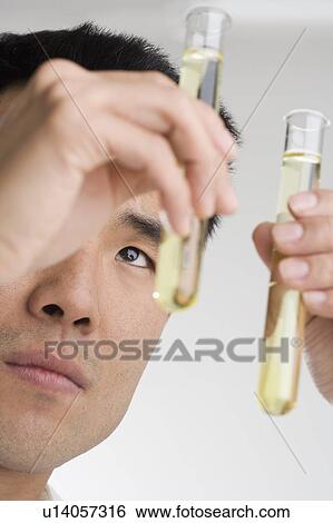 Scientist conducting an experiment View Large Photo Image Stock Photograph - Scientist conducting an experiment. Fotosearch