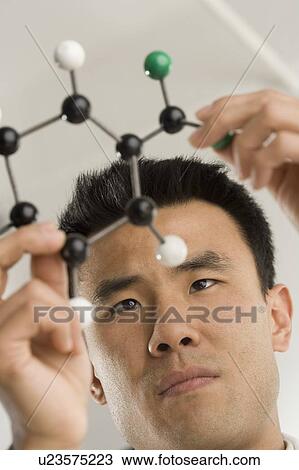 Scientist examining molecular structure View Large Photo Image Stock Image - Scientist examining molecular structure. Fotosearch