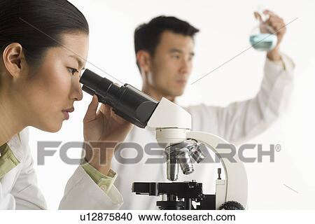 Scientists with beaker and microscope View Large Photo Image Stock Image - Scientists with beaker and microscope. Fotosearch