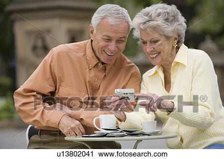 Senior couple having coffee at outdoor café View Large Photo Image Stock Image - Senior couple having coffee at outdoor café. Fotosearch