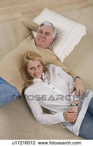 Senior couple lying on floor View Large Photo Image Stock Image - Senior couple lying on floor. Fotosearch