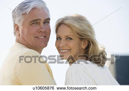 Stock Photograph - Senior couple smiling outdoors. Fotosearch