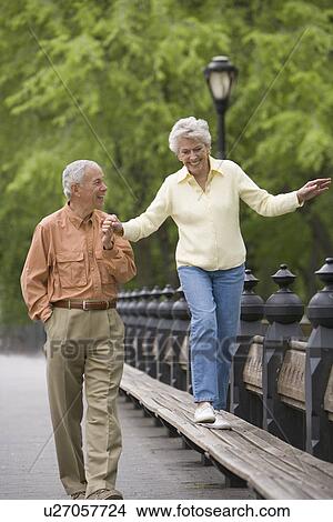 Senior couple walking in a park View Large Photo Image Picture - Senior couple walking in a park. Fotosearch