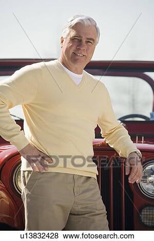 Senior man standing in front of jeep View Large Photo Image Stock Photo - Senior man standing in front of jeep. Fotosearch