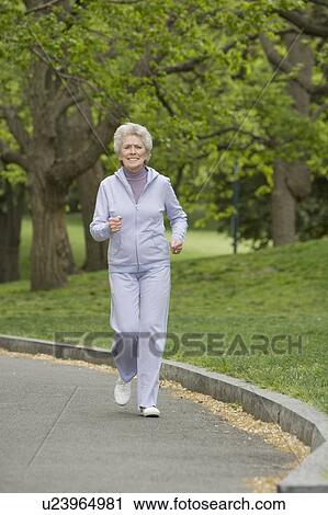 Stock Image - Senior woman power walking. Fotosearch