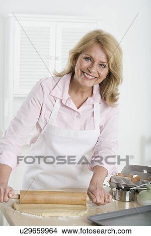 Picture - Senior woman rolling dough. Fotosearch