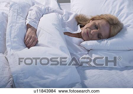 Senior woman sleeping in bed View Large Photo Image Picture - Senior woman sleeping in bed. Fotosearch