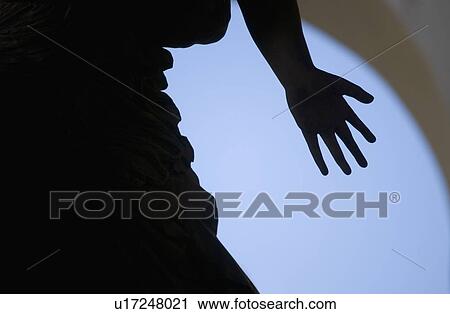 Stock Image - Silhouette of hand on statue Florence Italy. Fotosearch