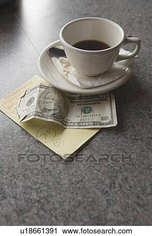 Stock Image - Sill life of cup of coffee money and check. Fotosearch