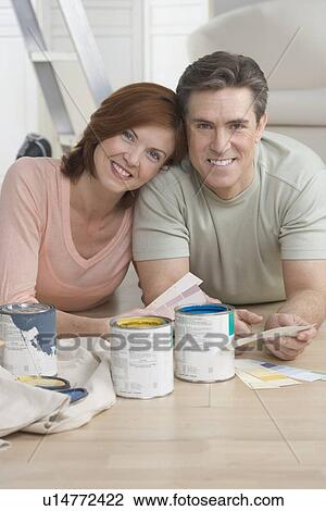 Smiling couple picking out paint colors View Large Photo Image Stock Image - Smiling couple picking out paint colors. Fotosearch