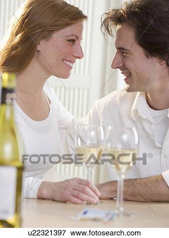Stock Photo - Smiling couple with glasses of wine. Fotosearch