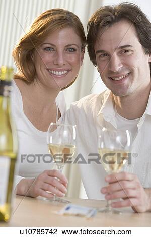 Smiling couple with white wine View Large Photo Image Stock Image - Smiling couple with white wine. Fotosearch