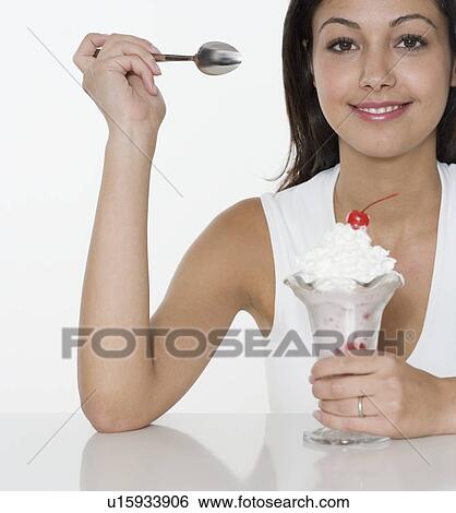 Smiling woman with ice cream sundae View Large Photo Image Stock Photograph - Smiling woman with ice cream sundae. Fotosearch