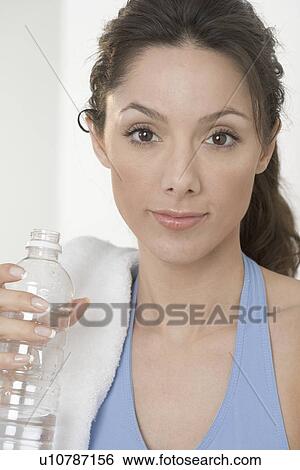 Smiling woman with water bottle View Large Photo Image Stock Photograph - Smiling woman with water bottle. Fotosearch
