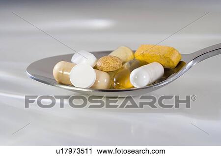 Stock Image - Still life of a spoonful of pills. Fotosearch
