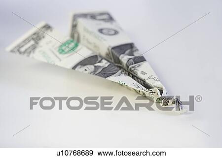 Stock Photo - Still life of airplane made from dollar bill. Fotosearch
