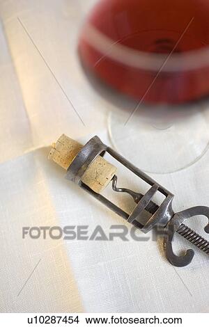 Picture - Still life of corkscrew and wine. Fotosearch