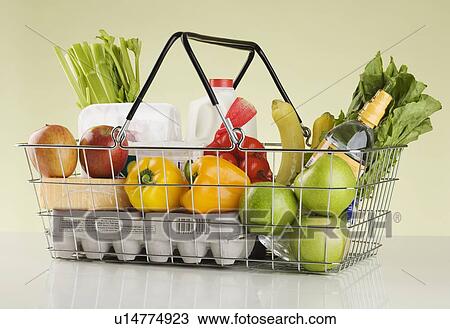 Stock Image - Still life of groceries in basket. Fotosearch