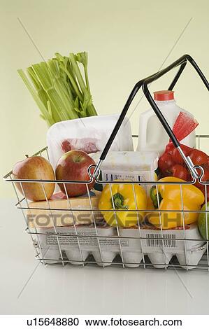 Stock Image - Still life of groceries in basket. Fotosearch