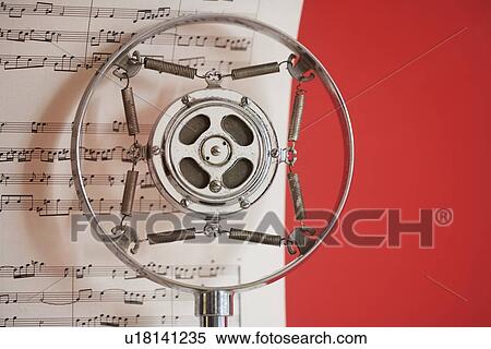 Stock Photography - Still life of microphone and sheet music. Fotosearch