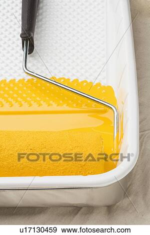 Still life of paint roller with yellow paint View Large Photo Image Stock Photo - Still life of paint roller with yellow paint. Fotosearch