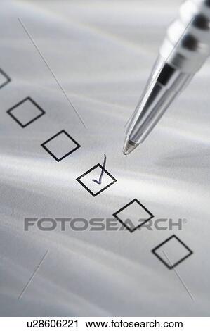 Stock Image - Still life of pen checking box. Fotosearch