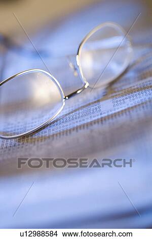 Picture - Still life of reading glasses and documents. Fotosearch