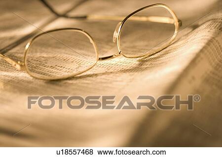 Stock Photo - Still life of reading glasses and documents. Fotosearch
