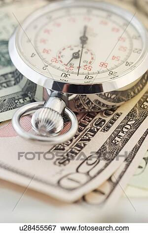 Still life of stopwatch and money View Large Photo Image Stock Photo - Still life of stopwatch and money. Fotosearch