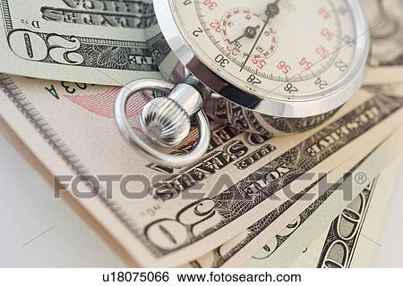 Still life of stopwatch and money View Large Photo Image Stock Photograph - Still life of stopwatch and money. Fotosearch