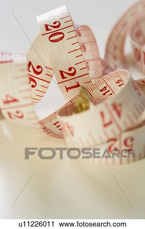 Stock Image - Still life of tape measure. Fotosearch
