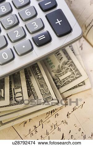 Picture - Still life of US money and calculator. Fotosearch