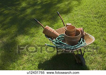 Still life of wheelbarrow and gardening tools View Large Photo Image Stock Photography - Still life of wheelbarrow and gardening tools. Fotosearch