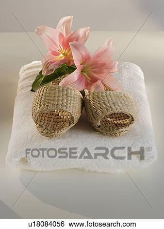 Straw sandals and flowers on folded towel View Large Photo Image Stock Photograph - Straw sandals and flowers on folded towel. Fotosearch