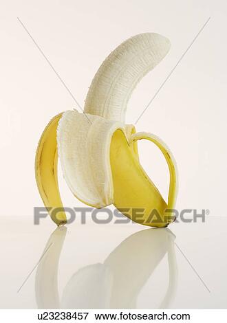 Studio shot of half peeled banana View Large Photo Image Stock Photo - Studio shot of half peeled banana. Fotosearch