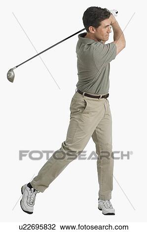 Stock Image - Studio shot of man playing golf. Fotosearch