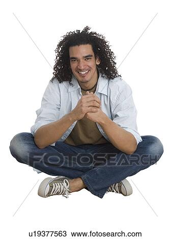 Studio shot of man sitting cross-legged View Large Photo Image Stock Image - Studio shot of man sitting cross-legged. Fotosearch