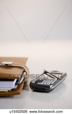 Studio shot of PDA and date planner book View Large Photo Image Stock Photograph - Studio shot of PDA and date planner book. Fotosearch
