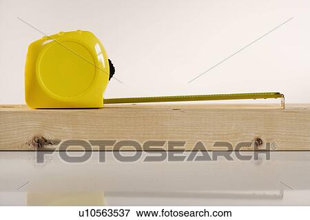 Studio shot of tape measure and wood View Large Photo Image Stock Photo - Studio shot of tape measure and wood. Fotosearch