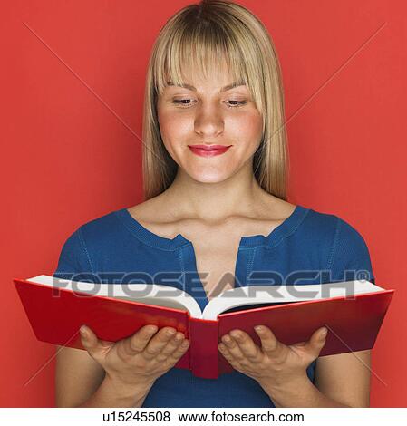 Stock Photo - Studio shot of woman reading a book. Fotosearch