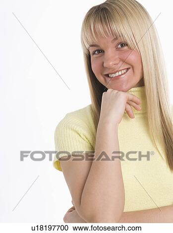 Stock Image - Studio shot of woman smiling. Fotosearch