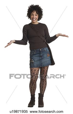 Studio shot of woman smiling with hands out View Large Photo Image Stock Photography - Studio shot of woman smiling with hands out. Fotosearch
