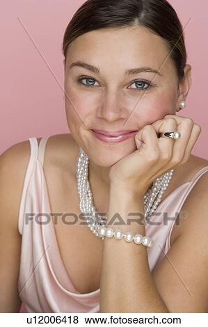 Stock Photo - Studio shot of woman wearing pearls. Fotosearch